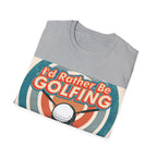 Folded grey t-shirt with 'I'd Rather Be Golfing' graphic design on a white background