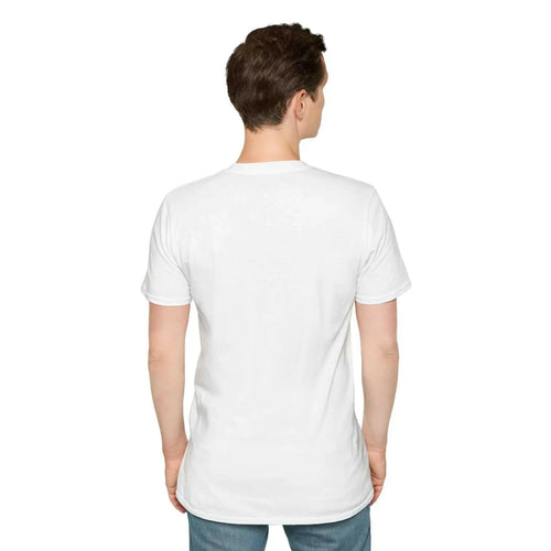 A man stands facing away from the camera wearing a white t-shirt and blue jeans.
