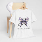 White t-shirt with a butterfly graphic and 'Metamorphosis' text on a wooden chair.